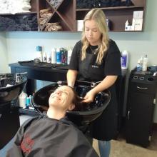brantford hairstyling students practicing shampooing washing hair wash and blowout brantford hair school salon